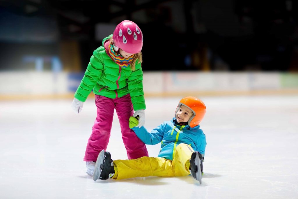 a little girl rides on a city ice rink in winter. High quality photo